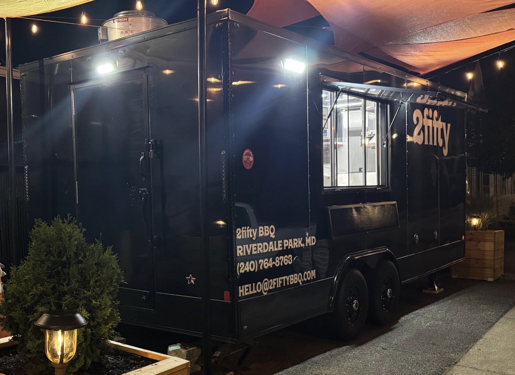 The Nite Bites trailer lit up at night outside 2fifty Riverdale Park